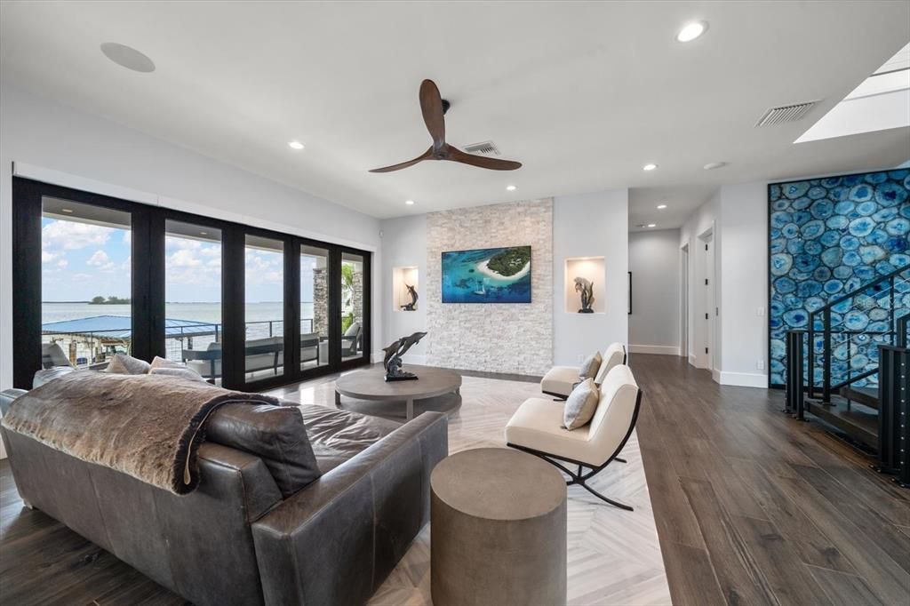 Fireplace, Interior, Living room, Recessed Lighting, Stone Walls, Water, Wood Texture Flooring