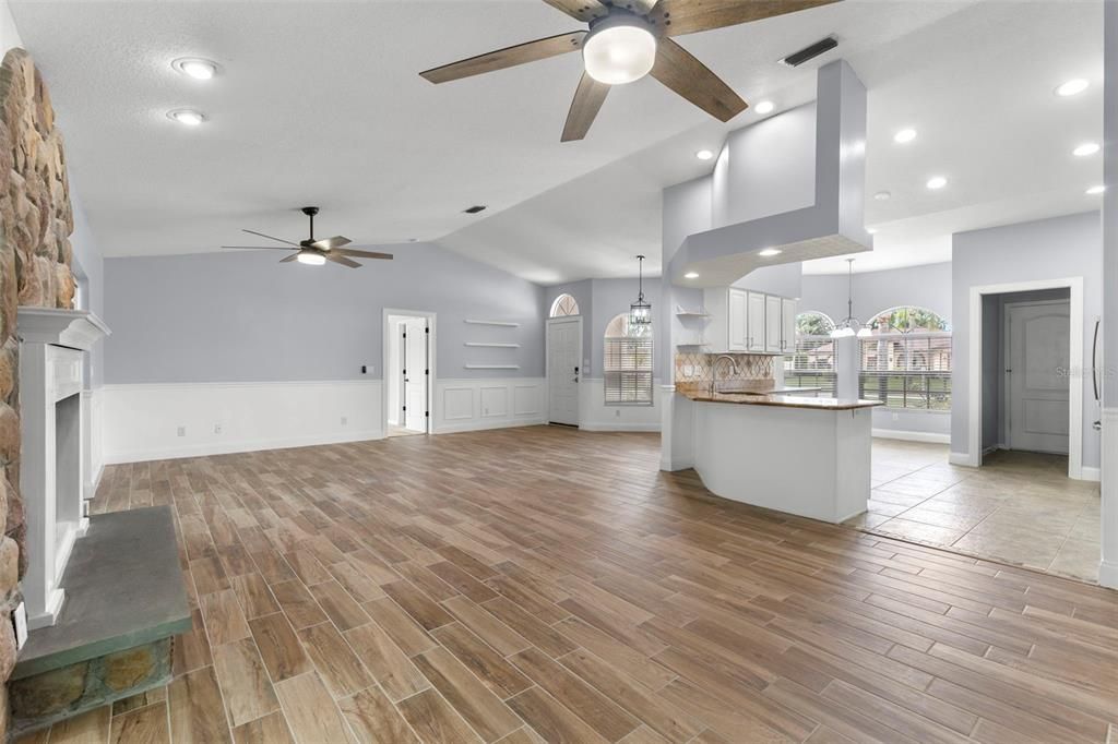 Empty room, Fireplace, Interior, Kitchen, Pendant Lights, Recessed Lighting, Wood Texture Flooring