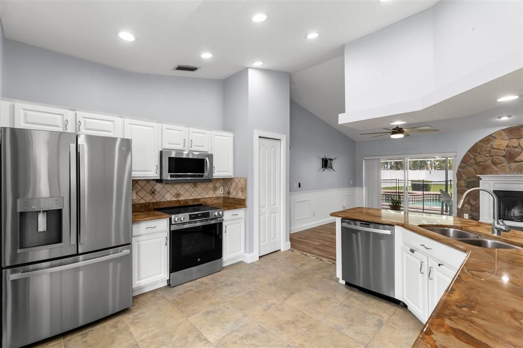 Fireplace, Interior, Kitchen, Recessed Lighting, Stainless Steel Appliances, Stone Walls