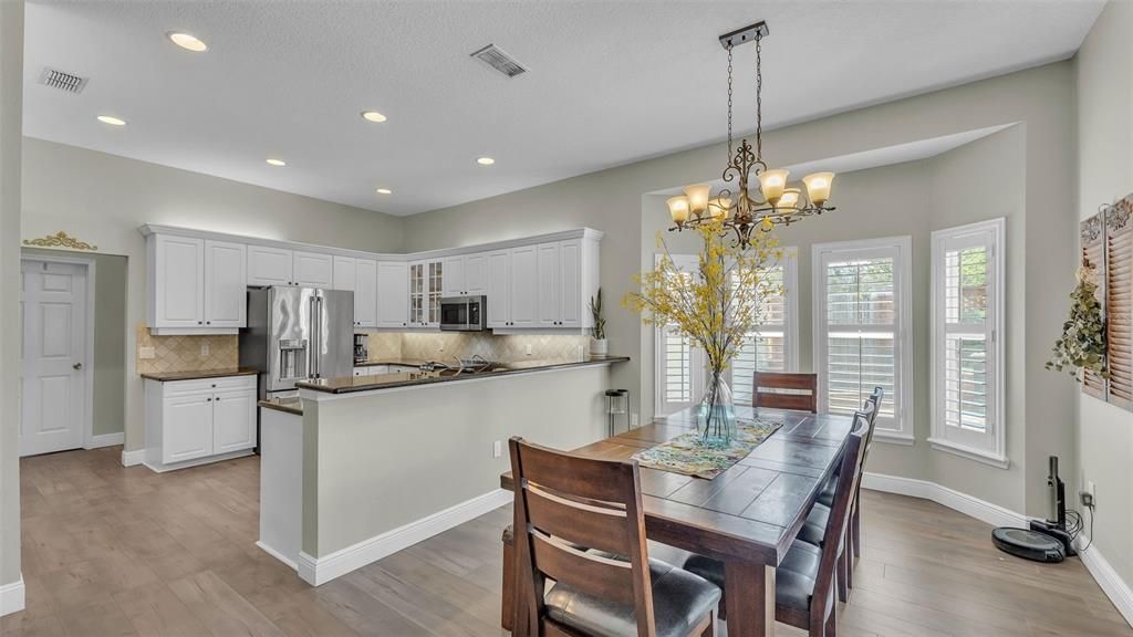 Chandelier, Dining room, Interior, Kitchen, Recessed Lighting, Stainless Steel Appliances, Wood Texture Flooring