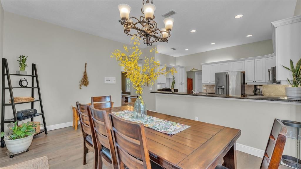 Chandelier, Dining room, Interior, Kitchen, Recessed Lighting, Stainless Steel Appliances, Wood Texture Flooring