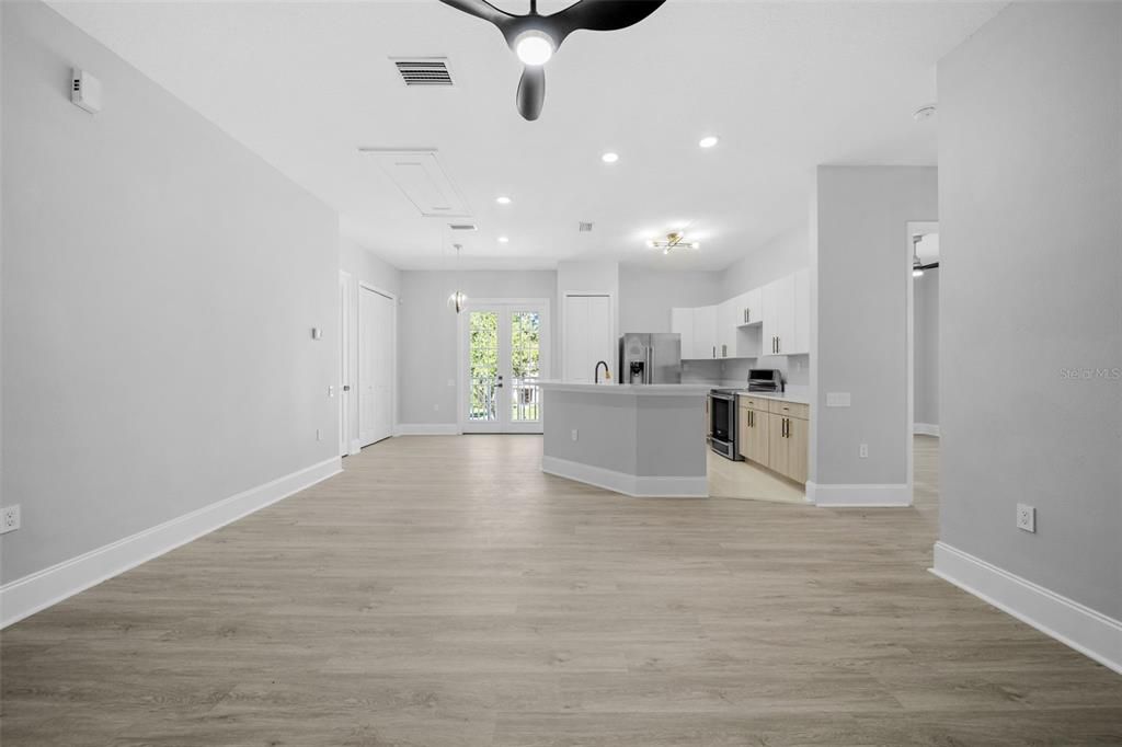 Empty room, Interior, Kitchen, Recessed Lighting, Stainless Steel Appliances, Wood Texture Flooring