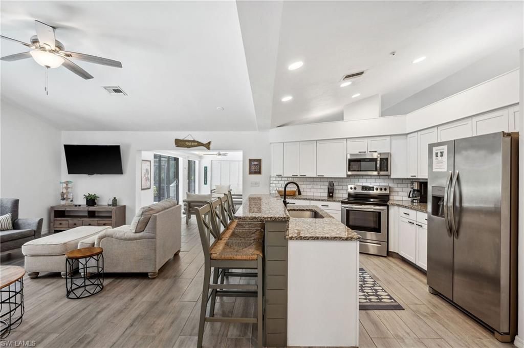 Dining room, Interior, Kitchen, Living room, Recessed Lighting, Stainless Steel Appliances, Wood Texture Flooring