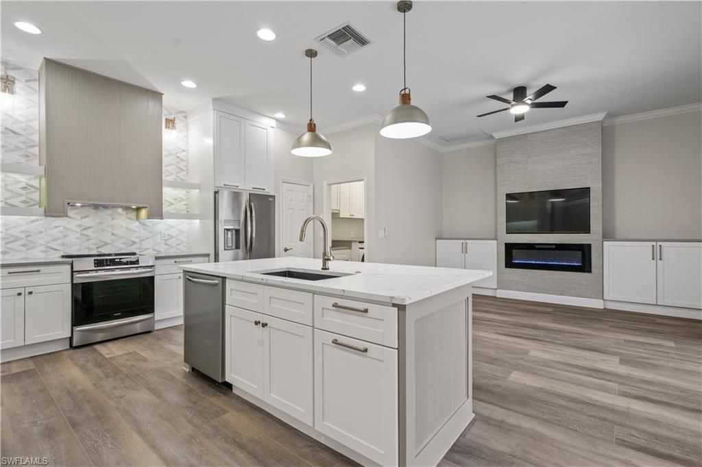 Fireplace, Interior, Kitchen, Pendant Lights, Recessed Lighting, Stainless Steel Appliances, Wood Texture Flooring