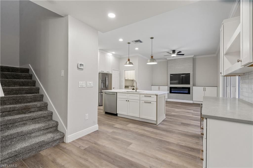 Fireplace, Interior, Kitchen, Pendant Lights, Recessed Lighting, Stainless Steel Appliances, Wood Texture Flooring