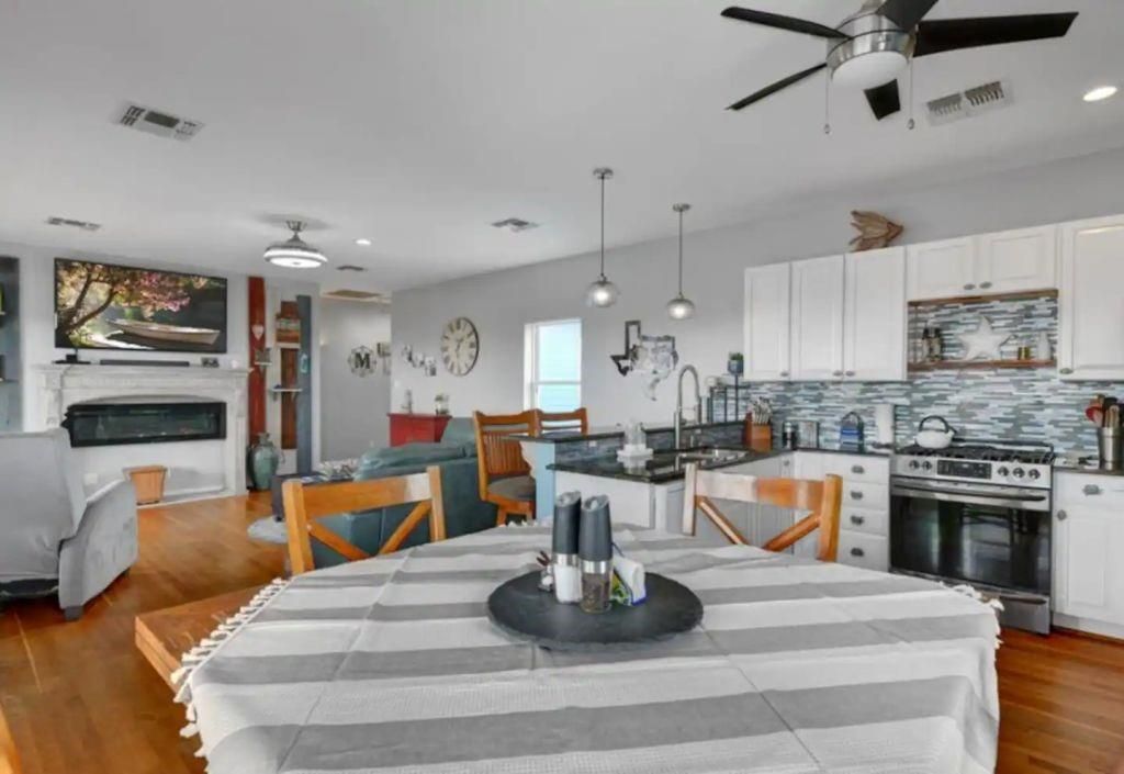 Dining room, Fireplace, Interior, Kitchen, Pendant Lights, Recessed Lighting, Stainless Steel Appliances, Wood Texture Flooring