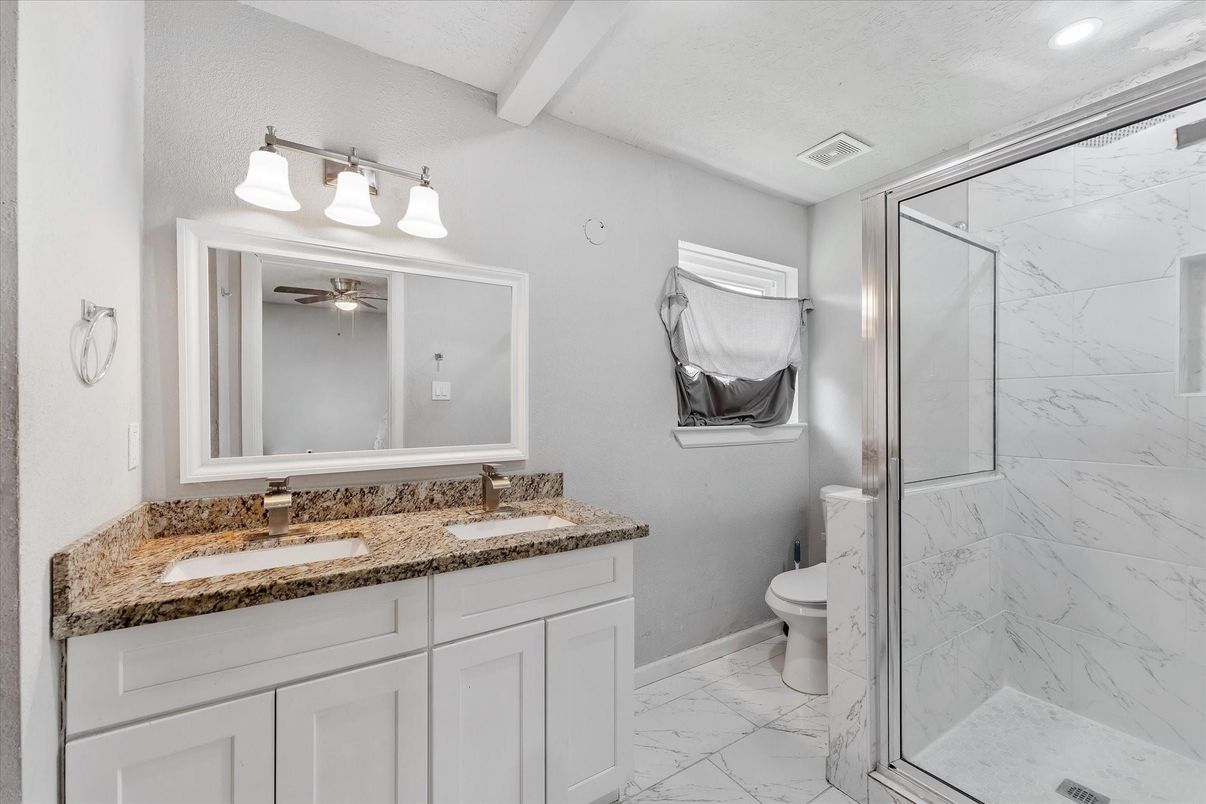 Bathroom, Dual Sink Vanities, Glass Shower, Interior, Marble, Marble Walls, Recessed Lighting