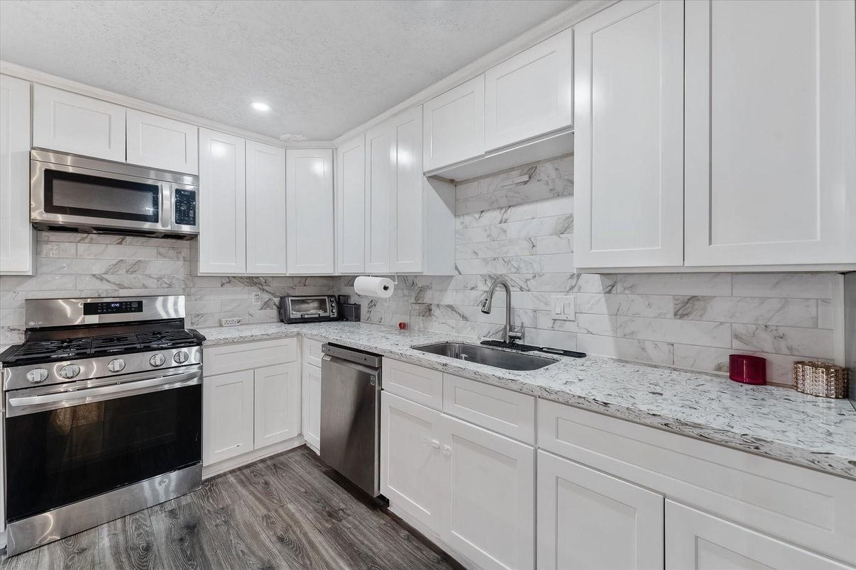 Interior, Kitchen, Marble Walls, Recessed Lighting, Stainless Steel Appliances, Wood Texture Flooring