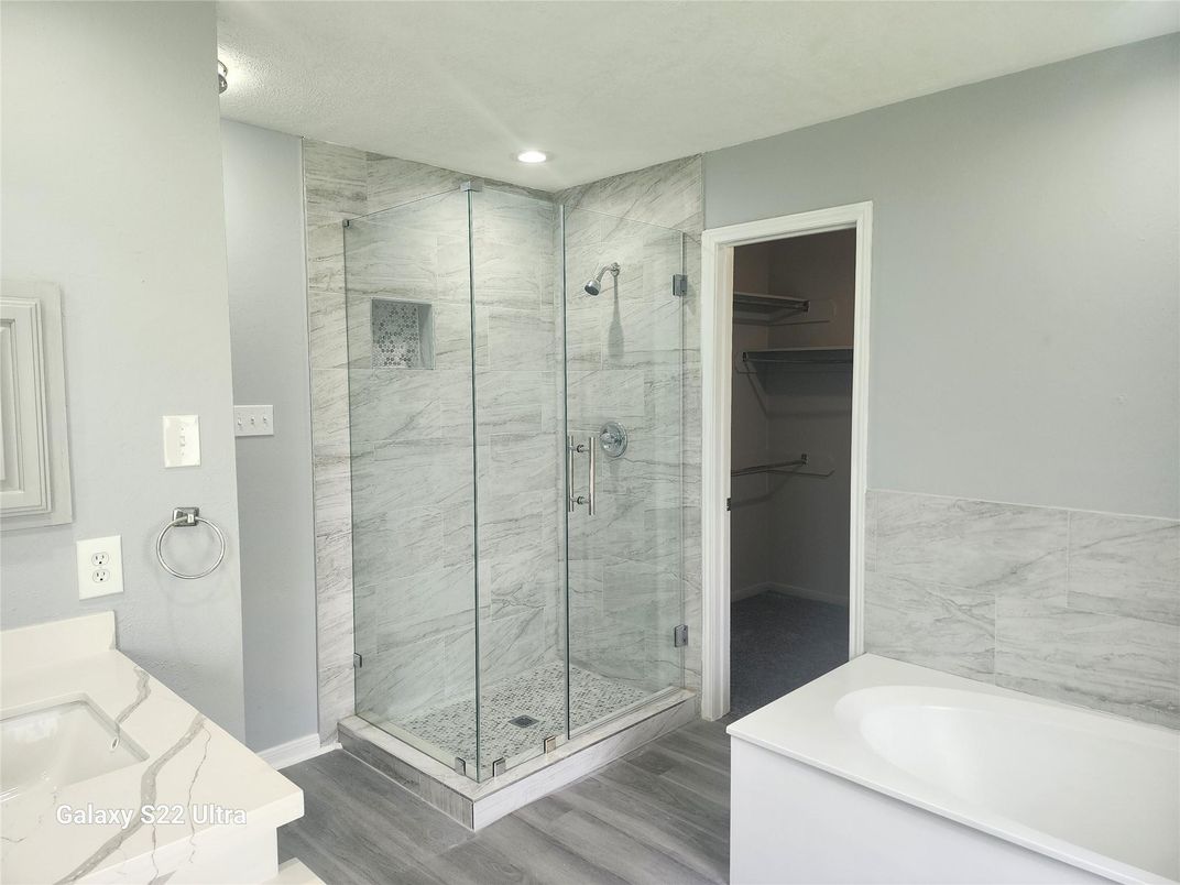 Bathroom, Glass Shower, Interior, Marble Walls, Recessed Lighting, Wood Texture Flooring