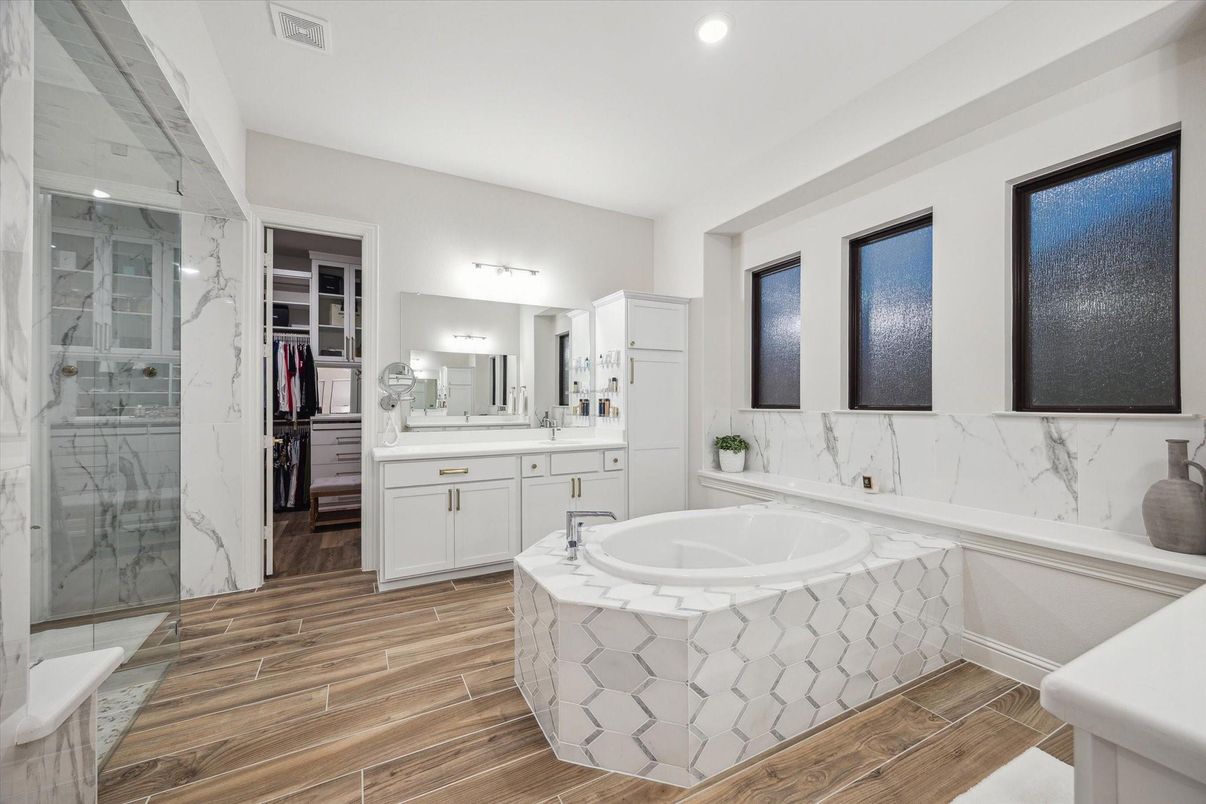 Bathroom, Dual Sink Vanities, Glass Shower, Interior, Marble Walls, Recessed Lighting, Wood Texture Flooring