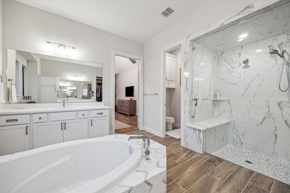 Bathroom, Dual Sink Vanities, Glass Shower, Interior, Marble Walls, Recessed Lighting, Wood Texture Flooring
