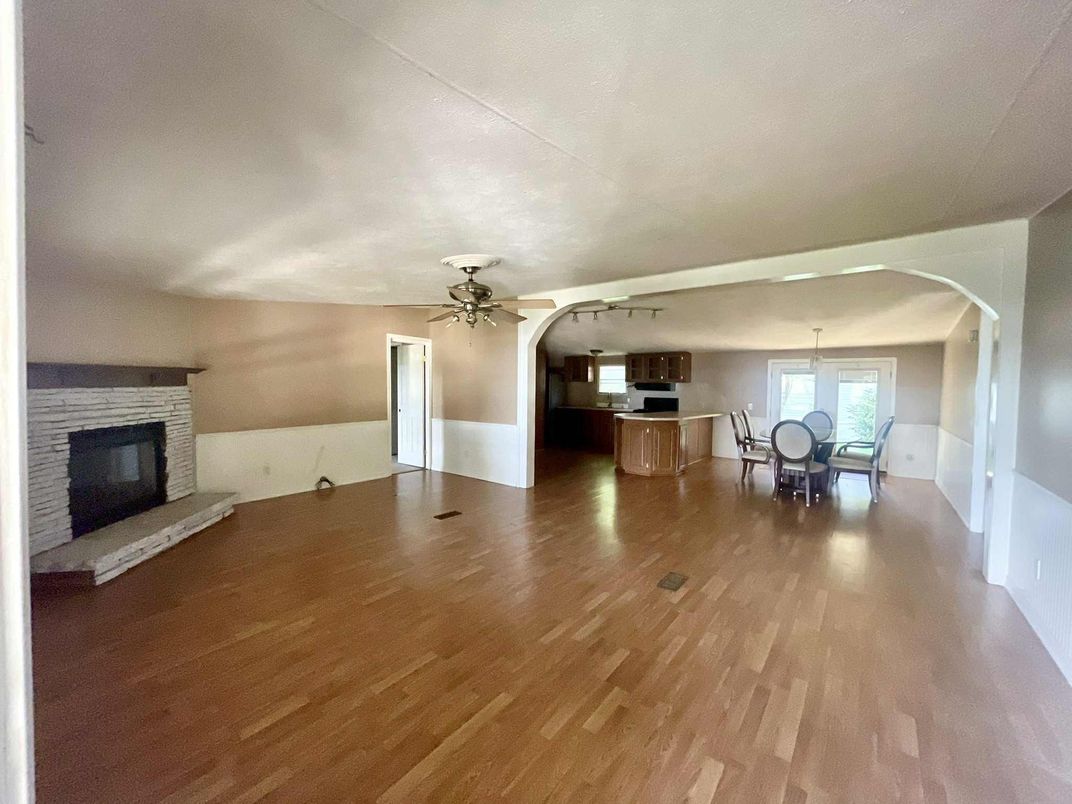 Dining room, Empty room, Fireplace, Interior, Kitchen, Pendant Lights, Stone Walls, Wood Texture Flooring