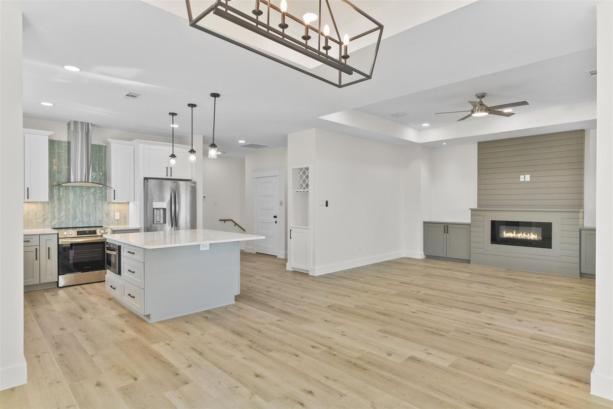 Fireplace, Interior, Kitchen, Pendant Lights, Recessed Lighting, Stainless Steel Appliances, Wood Texture Flooring