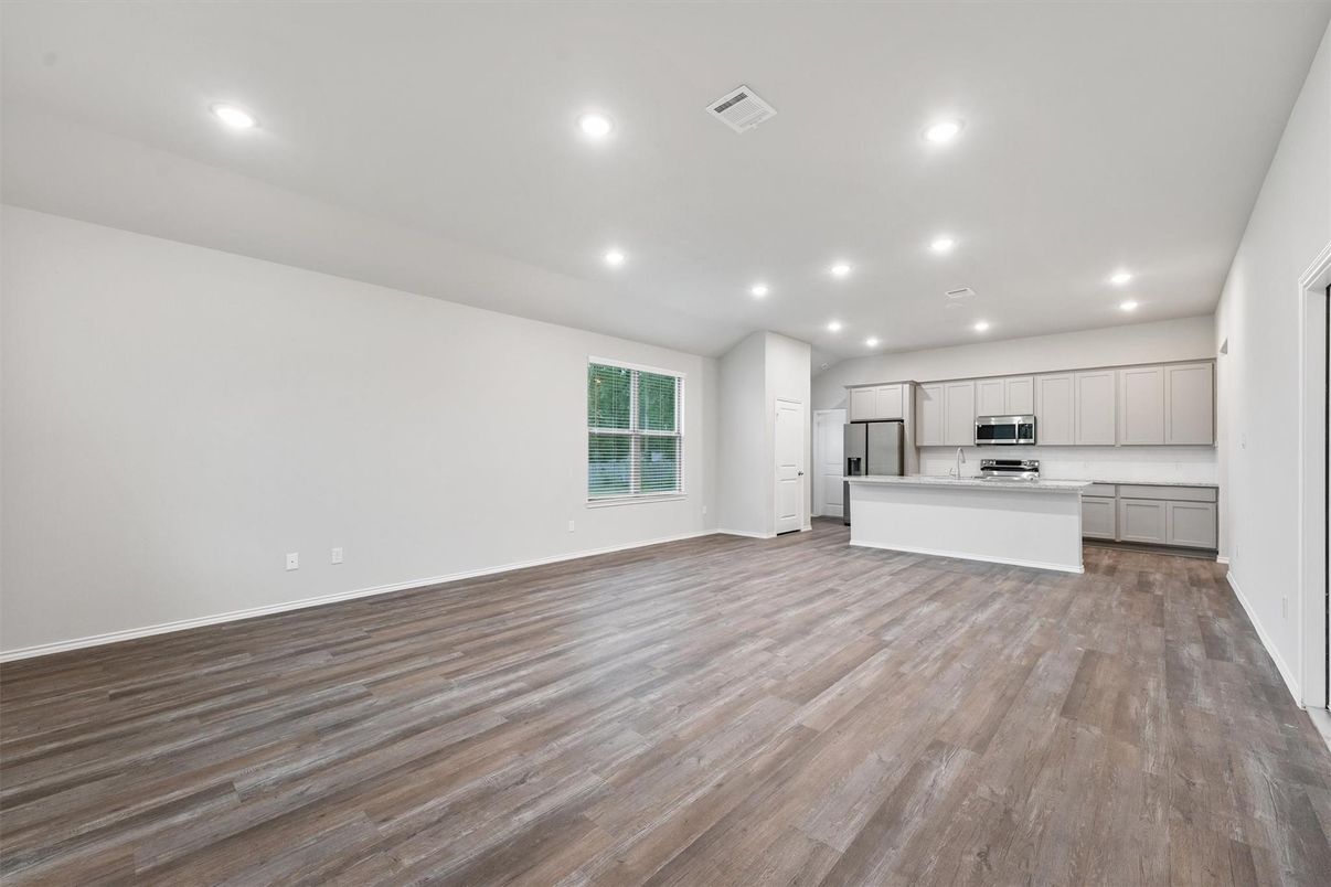 Empty room, Interior, Kitchen, Recessed Lighting, Stainless Steel Appliances, Wood Texture Flooring