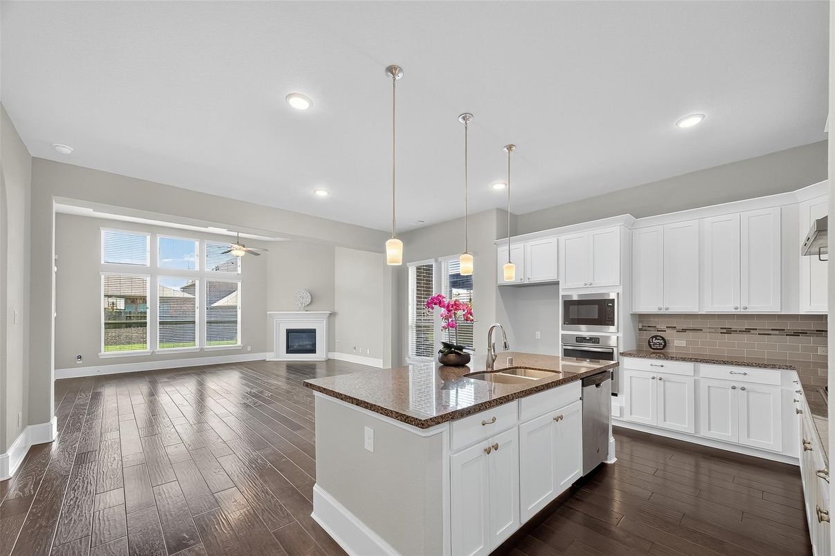 Fireplace, Interior, Kitchen, Pendant Lights, Recessed Lighting, Stainless Steel Appliances, Wood Texture Flooring
