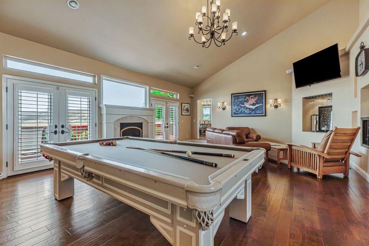 Billiard Table, Chandelier, Fireplace, Game Room, Interior, Living room, Recessed Lighting, Wood Texture Flooring