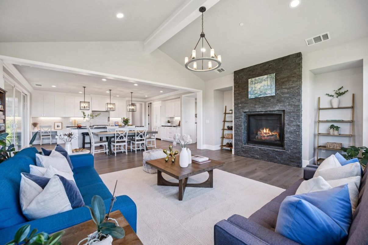 Chandelier, Dining room, Fireplace, Interior, Kitchen, Living room, Pendant Lights, Recessed Lighting, Stainless Steel Appliances, Stone Walls, Wood Texture Flooring