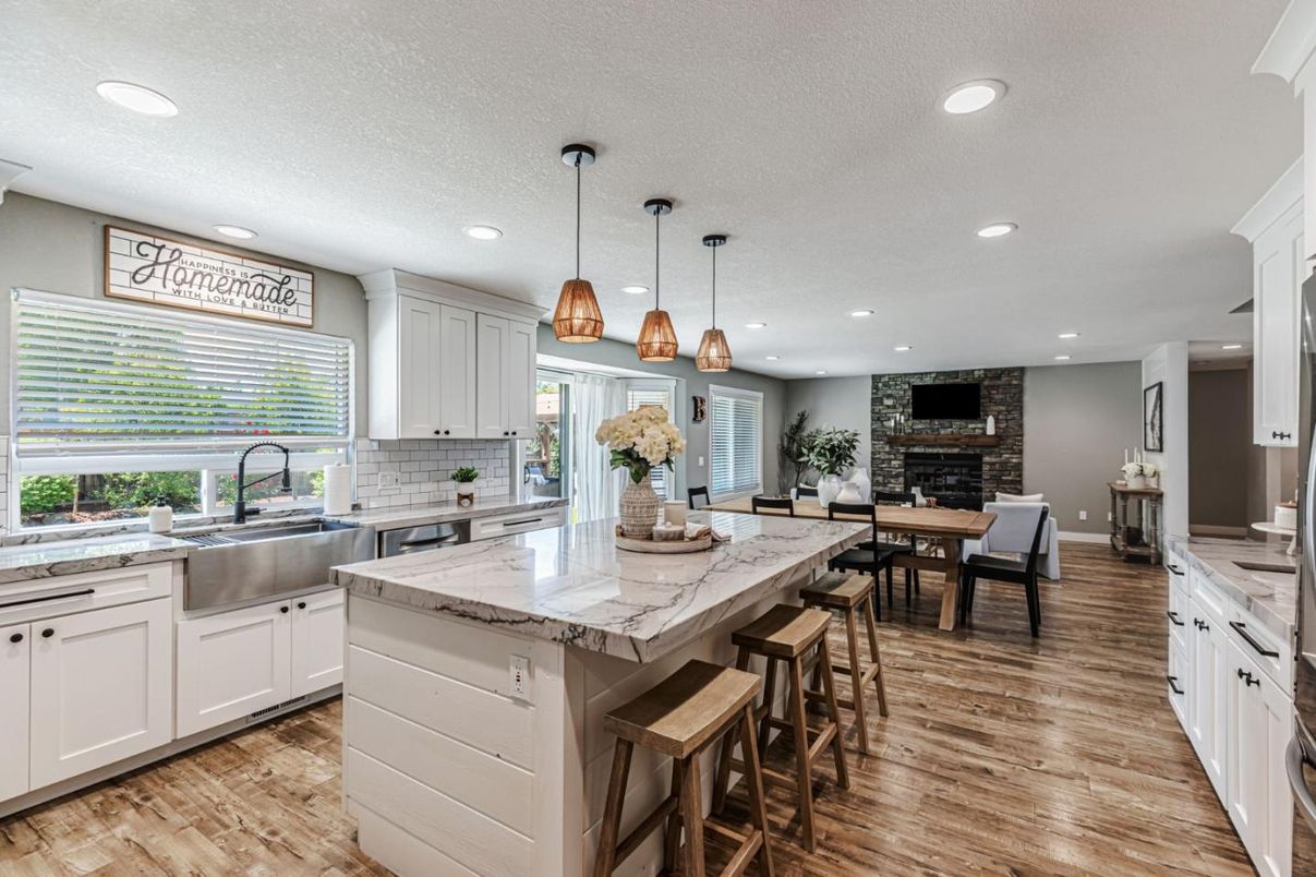 Dining room, Fireplace, Interior, Kitchen, Pendant Lights, Recessed Lighting, Stainless Steel Appliances, Stone Walls, Wood Texture Flooring