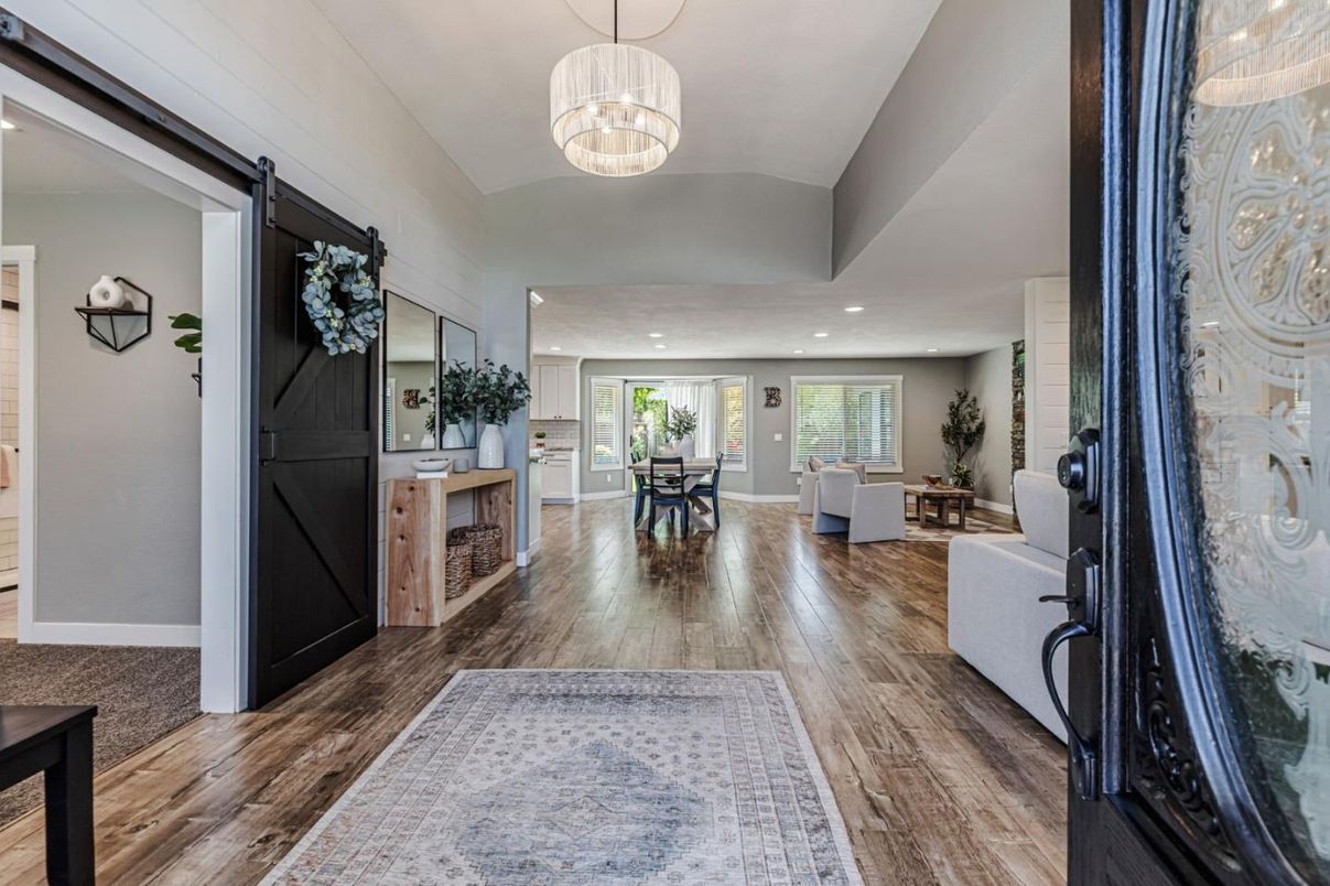 Chandelier, Dining room, Fireplace, Interior, Living room, Pendant Lights, Recessed Lighting, Wood Texture Flooring