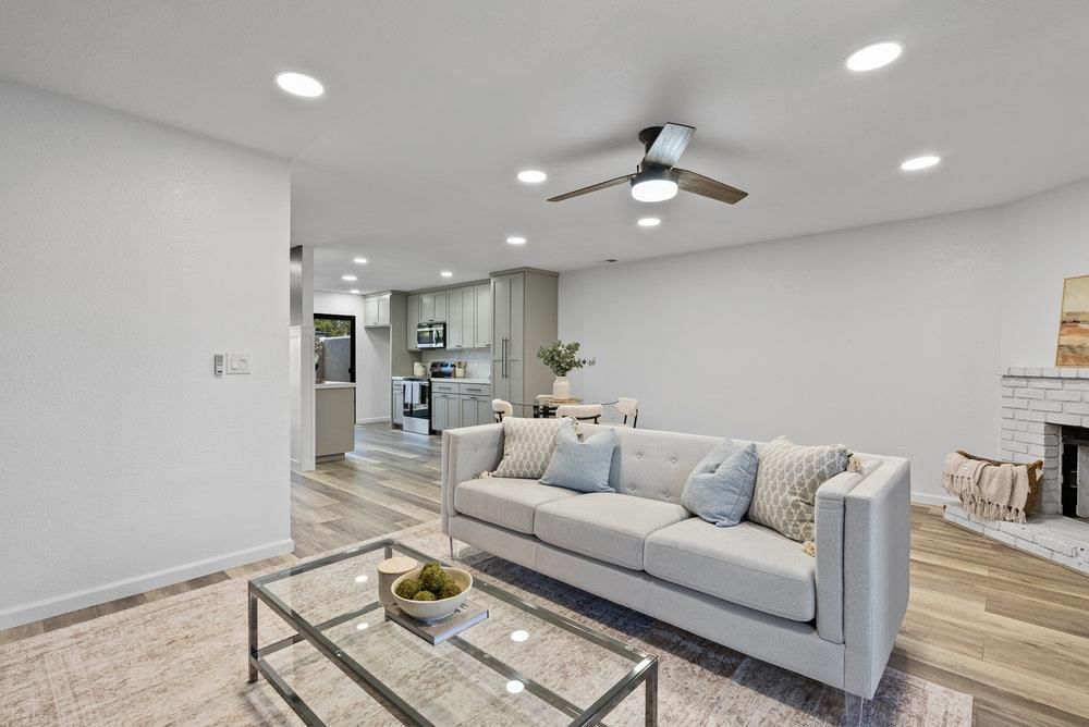 Dining room, Fireplace, Interior, Kitchen, Living room, Recessed Lighting, Stainless Steel Appliances, Wood Texture Flooring
