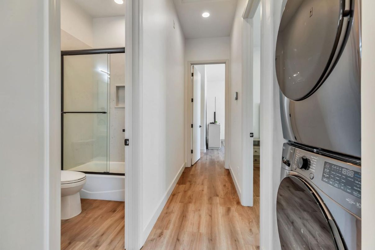 Bathroom, Glass Shower, Interior, Recessed Lighting, Washer, Wood Texture Flooring