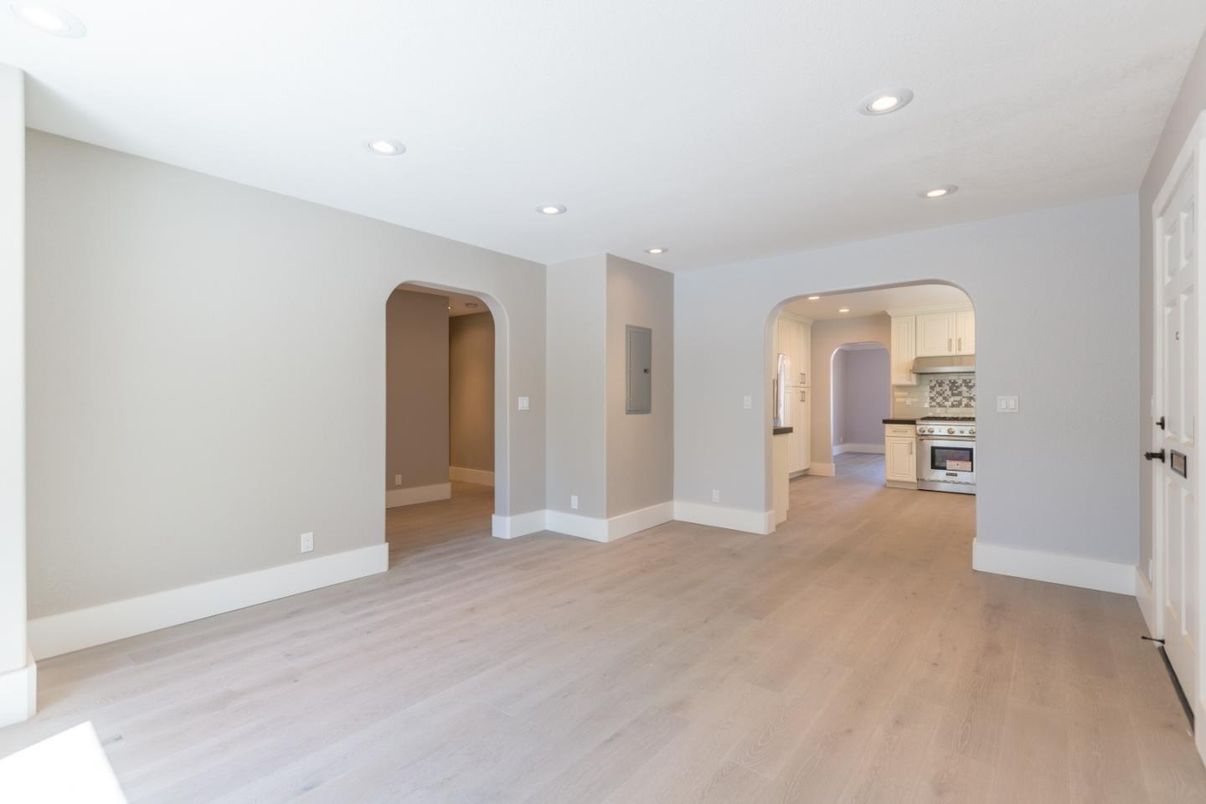 Empty room, Interior, Kitchen, Recessed Lighting, Stainless Steel Appliances, Wood Texture Flooring