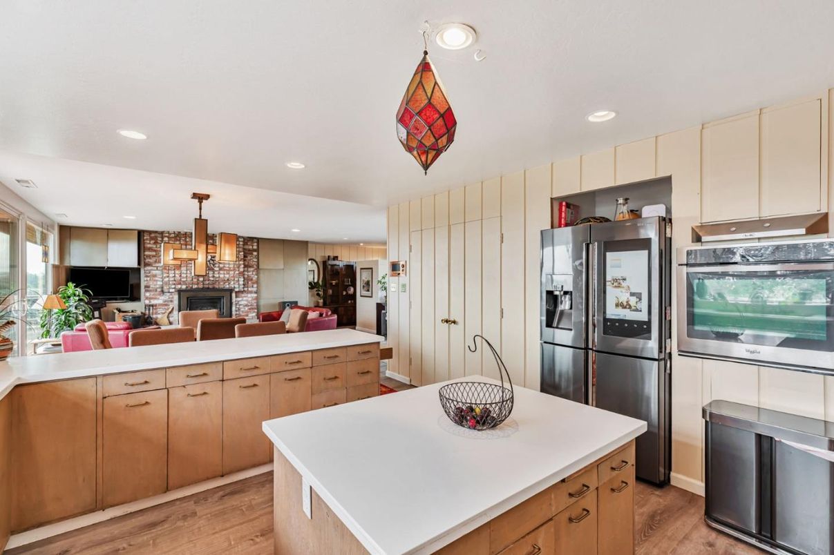 Fireplace, Interior, Kitchen, Pendant Lights, Recessed Lighting, Stainless Steel Appliances, Stone Walls, Wood Texture Flooring