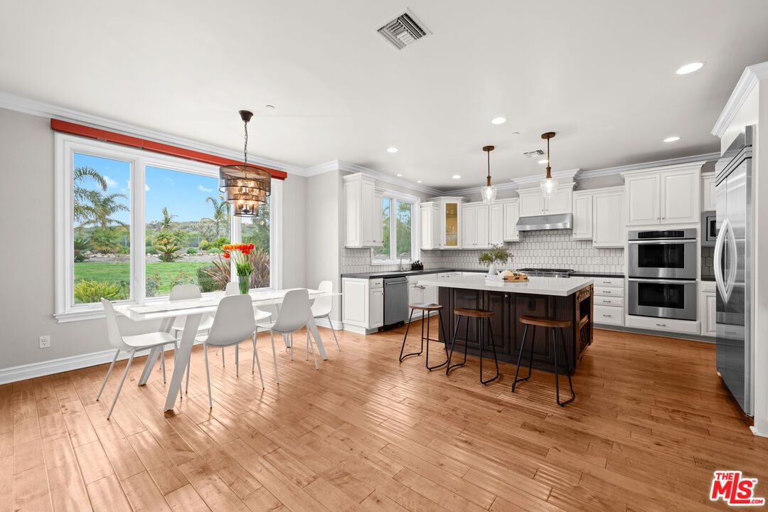 Dining room, Interior, Kitchen, Pendant Lights, Recessed Lighting, Stainless Steel Appliances, Wood Texture Flooring