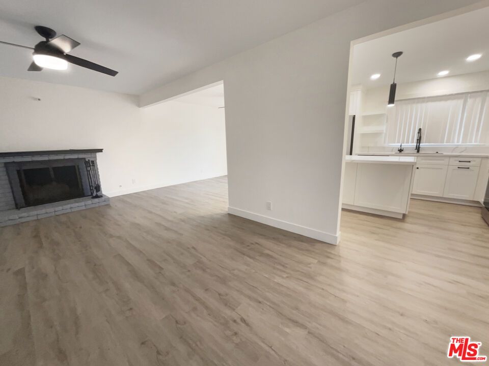 Empty room, Fireplace, Interior, Kitchen, Pendant Lights, Recessed Lighting, Wood Texture Flooring