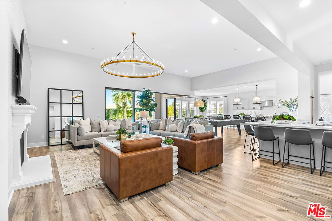 Chandelier, Dining room, Fireplace, Interior, Living room, Pendant Lights, Recessed Lighting, Wood Texture Flooring