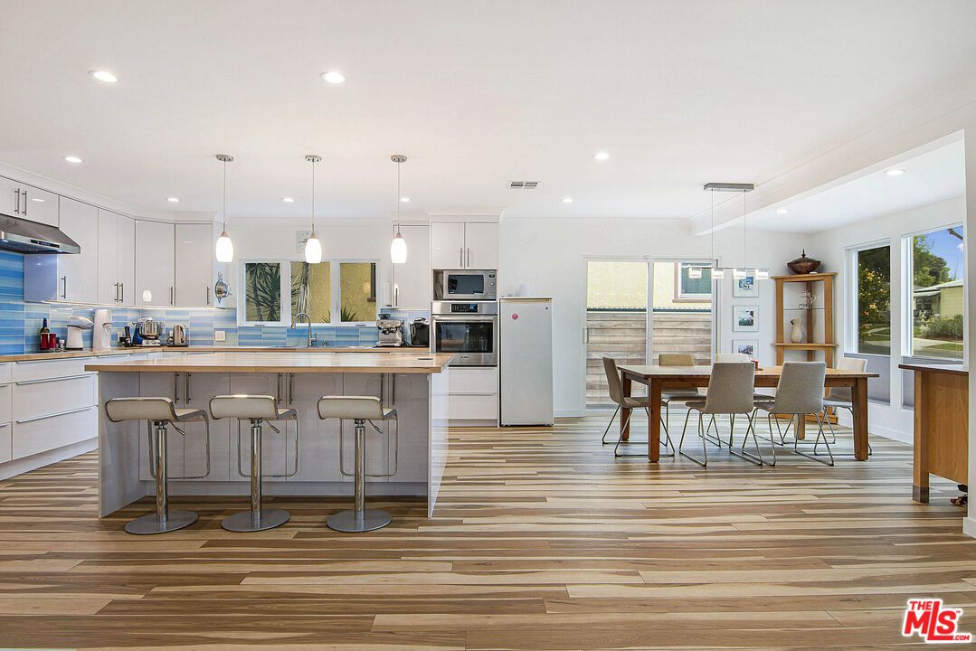 Dining room, Interior, Kitchen, Pendant Lights, Recessed Lighting, Stainless Steel Appliances, Wood Texture Flooring