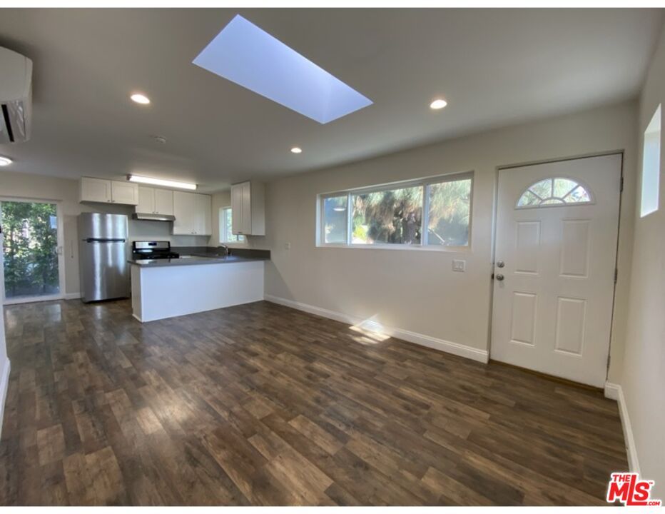 Empty room, Interior, Kitchen, Recessed Lighting, Stainless Steel Appliances, Wood Texture Flooring