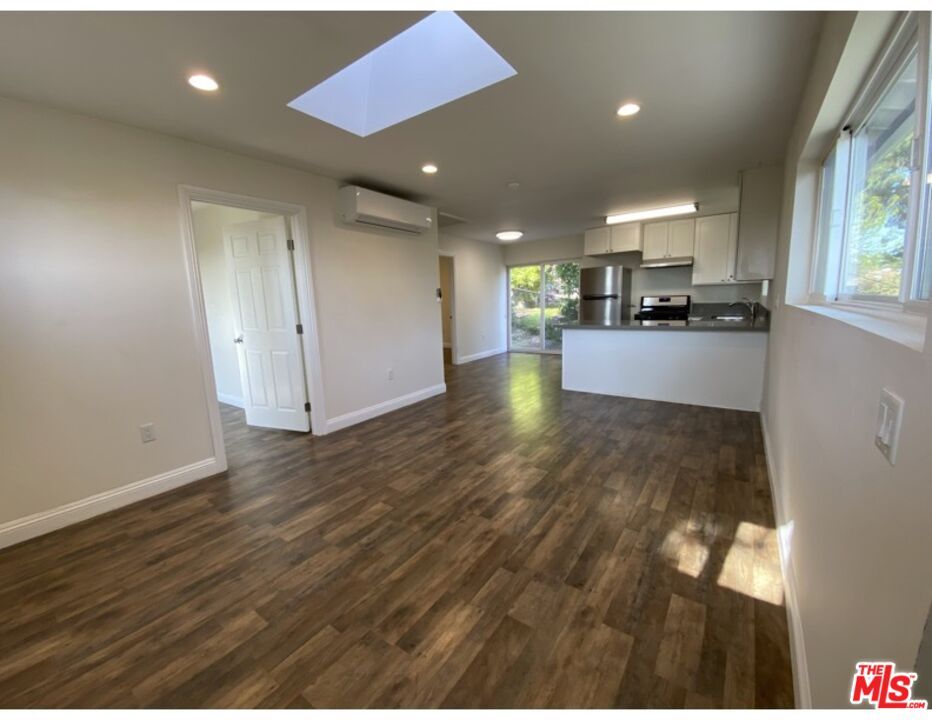 Empty room, Interior, Kitchen, Recessed Lighting, Stainless Steel Appliances, Wood Texture Flooring