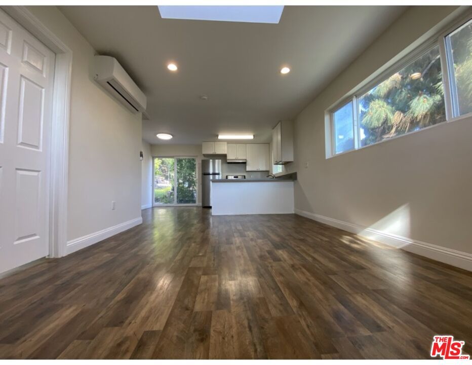 Empty room, Interior, Kitchen, Recessed Lighting, Stainless Steel Appliances, Wood Texture Flooring