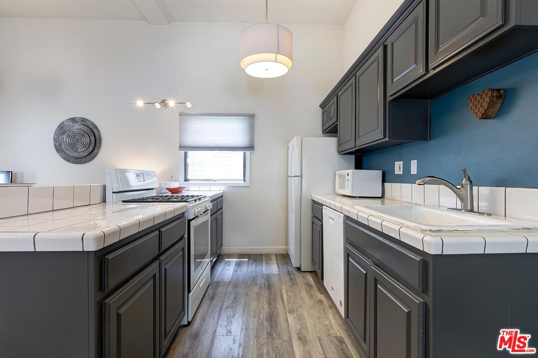 Interior, Kitchen, Pendant Lights, Tile Countertops, Wood Texture Flooring