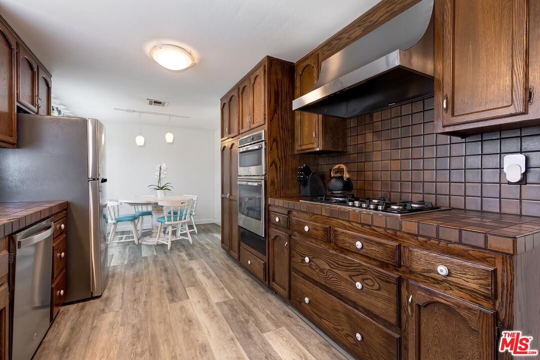 Dining room, Interior, Kitchen, Pendant Lights, Stainless Steel Appliances, Tile Countertops, Wood Texture Flooring