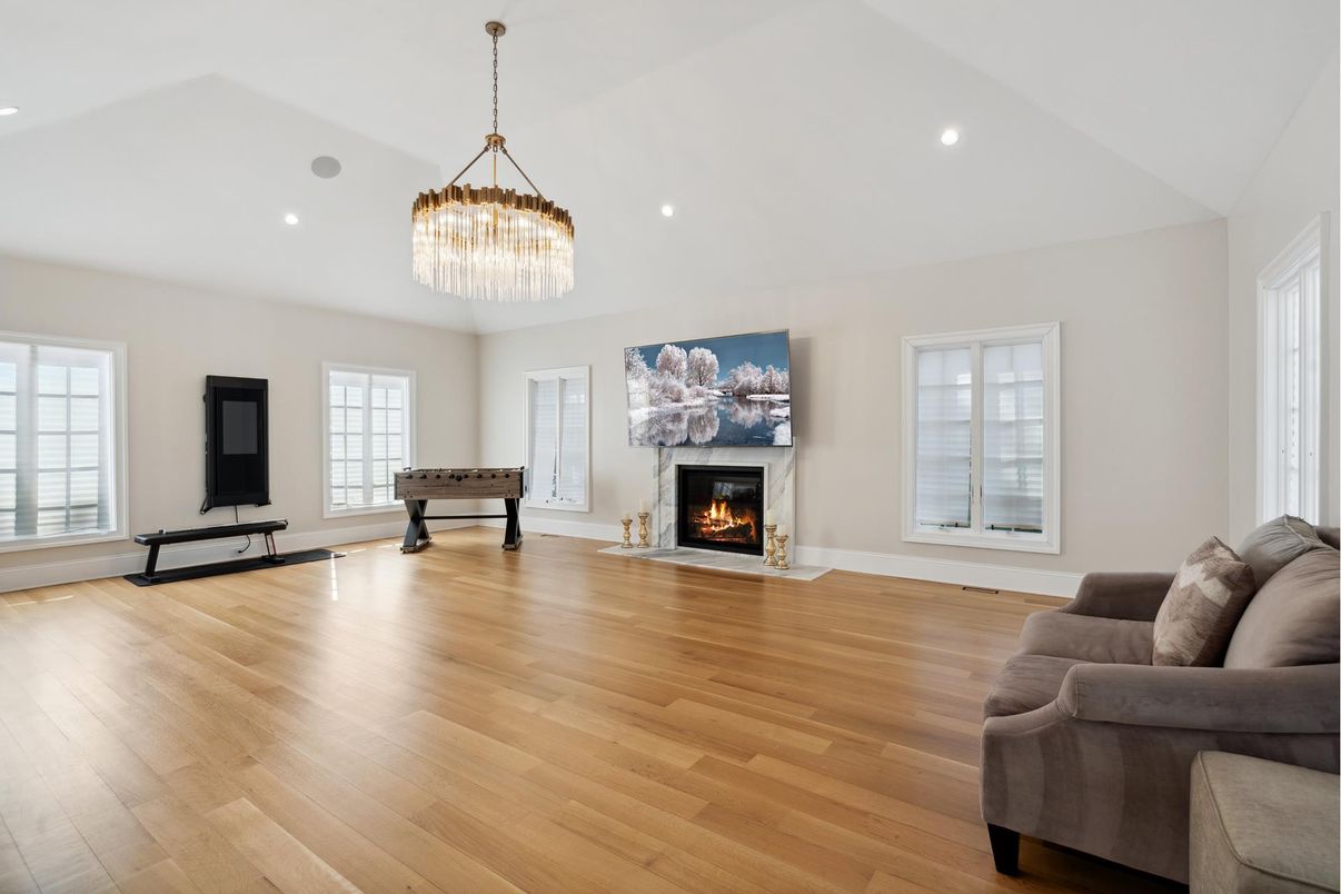 Billiard Table, Chandelier, Fireplace, Game Room, Interior, Living room, Pendant Lights, Recessed Lighting, Wood Texture Flooring