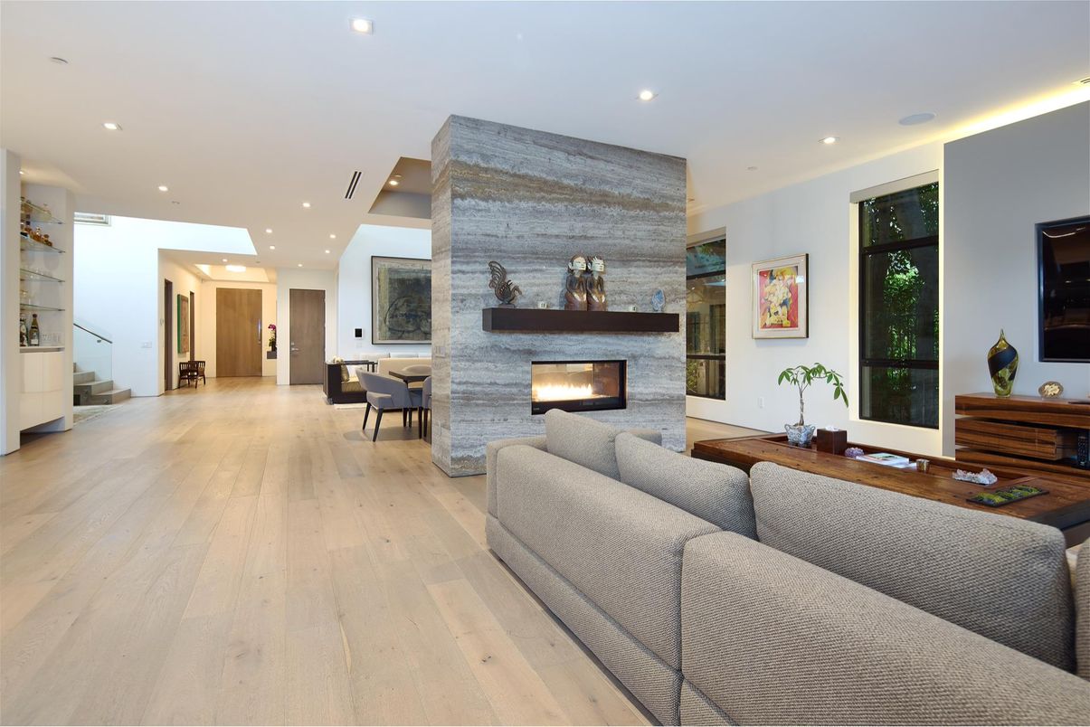 Dining room, Fireplace, Interior, Living room, Recessed Lighting, Stone Walls, Wood Texture Flooring