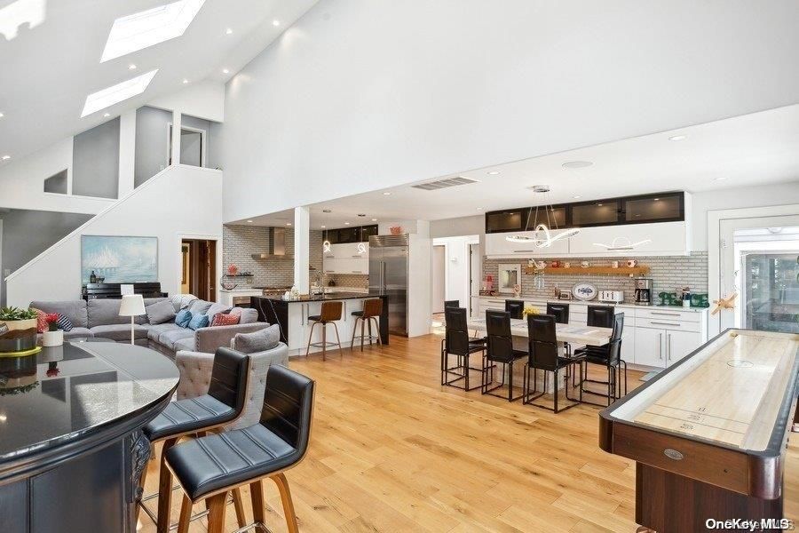Dining room, Interior, Kitchen, Living room, Pendant Lights, Recessed Lighting, Stainless Steel Appliances, Stone Walls, Wood Texture Flooring