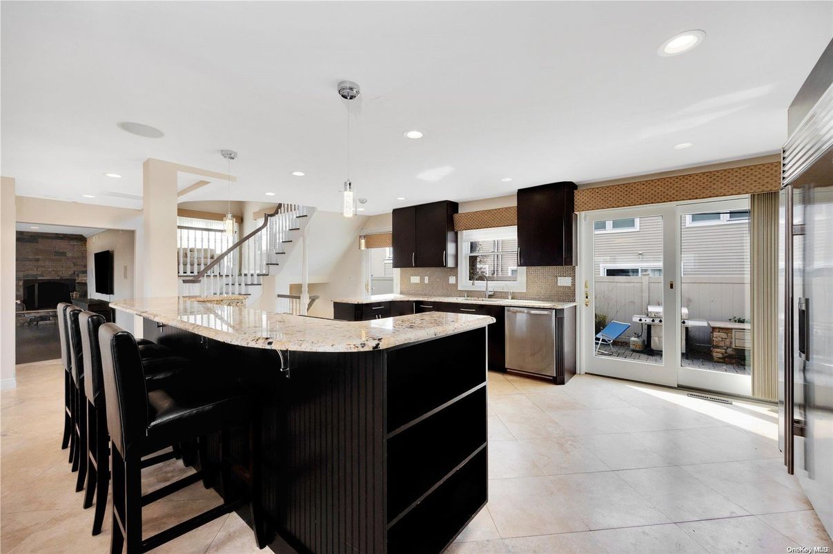 Fireplace, Interior, Kitchen, Pendant Lights, Recessed Lighting, Stainless Steel Appliances, Stone Walls