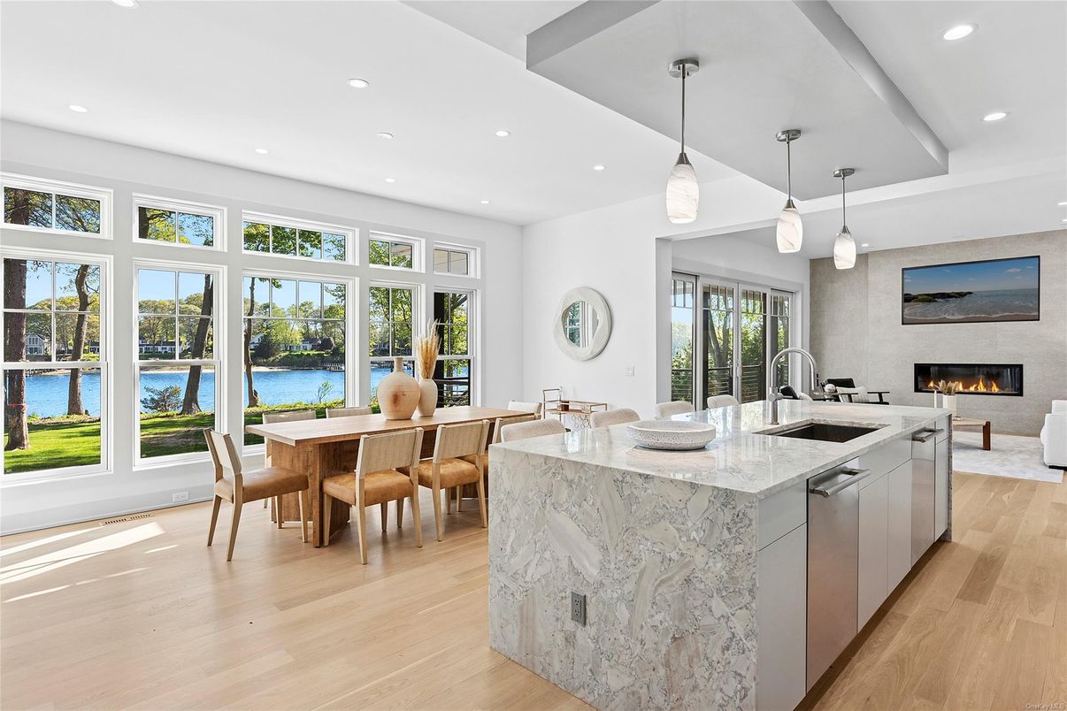 Dining room, Fireplace, Interior, Kitchen, Living room, Pendant Lights, Recessed Lighting, Water, Wood Texture Flooring