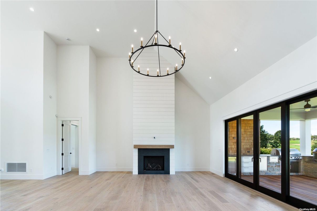 Chandelier, Empty room, Fireplace, Interior, Pendant Lights, Recessed Lighting, Wood Texture Flooring