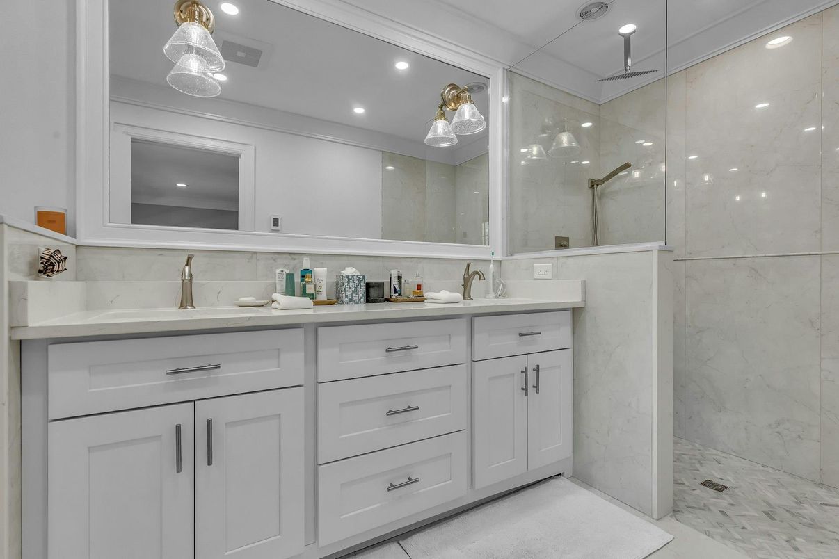 Bathroom, Dual Sink Vanities, Glass Shower, Interior, Marble, Marble Walls, Pendant Lights, Recessed Lighting