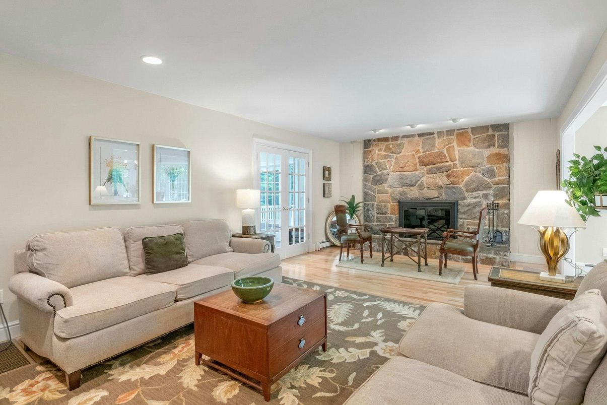 Dining room, Fireplace, Interior, Living room, Recessed Lighting, Stone Walls, Wood Texture Flooring