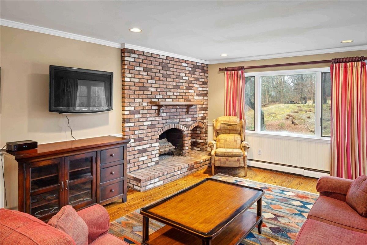 Fireplace, Interior, Living room, Recessed Lighting, Stone Walls, Wood Texture Flooring
