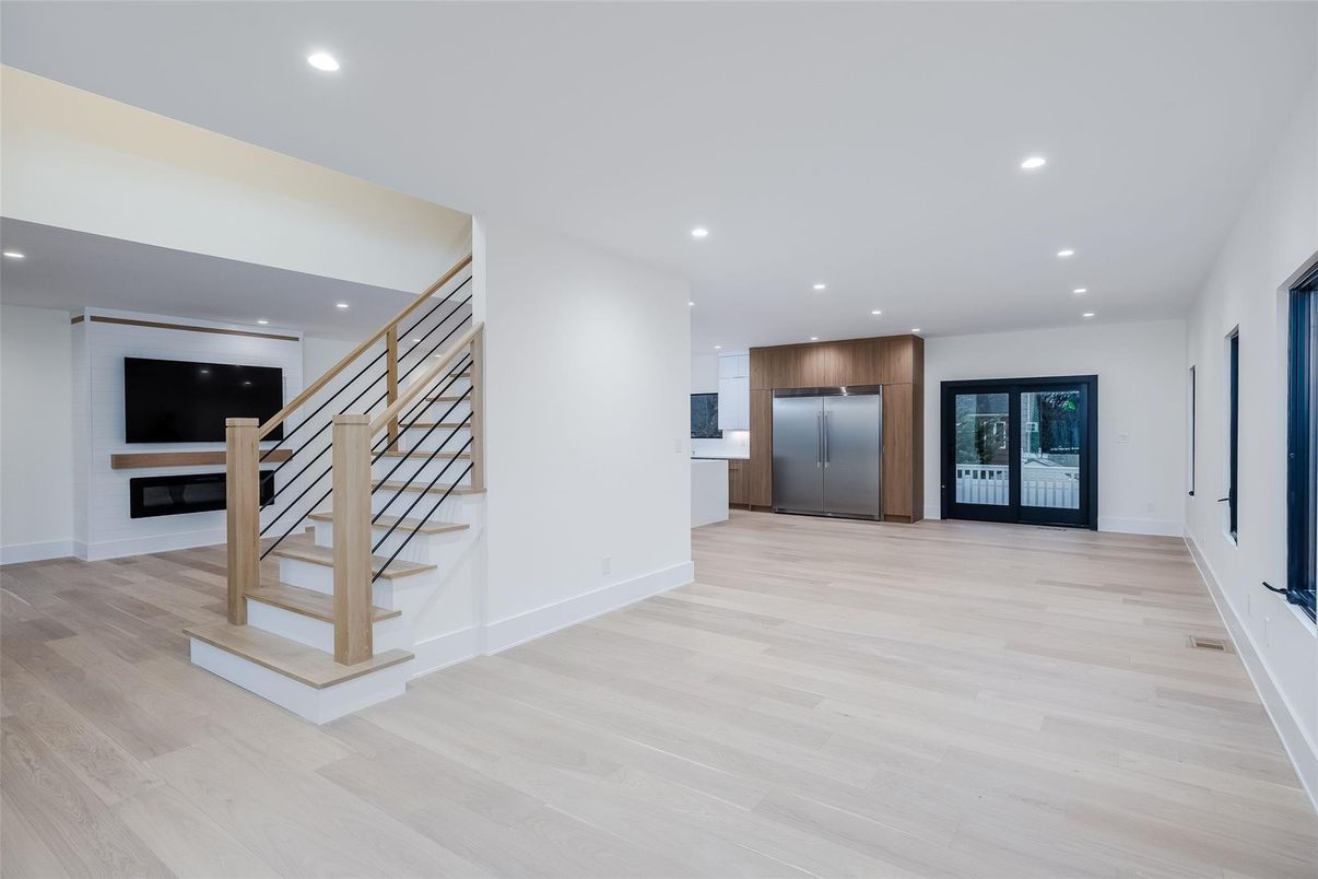 Empty room, Interior, Kitchen, Recessed Lighting, Stainless Steel Appliances, Wood Texture Flooring