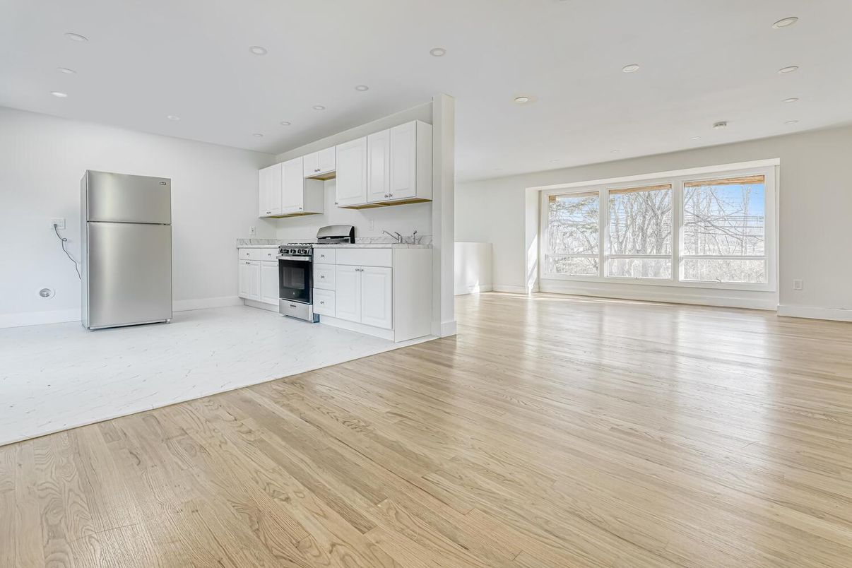 Empty room, Interior, Kitchen, Recessed Lighting, Stainless Steel Appliances, Wood Texture Flooring