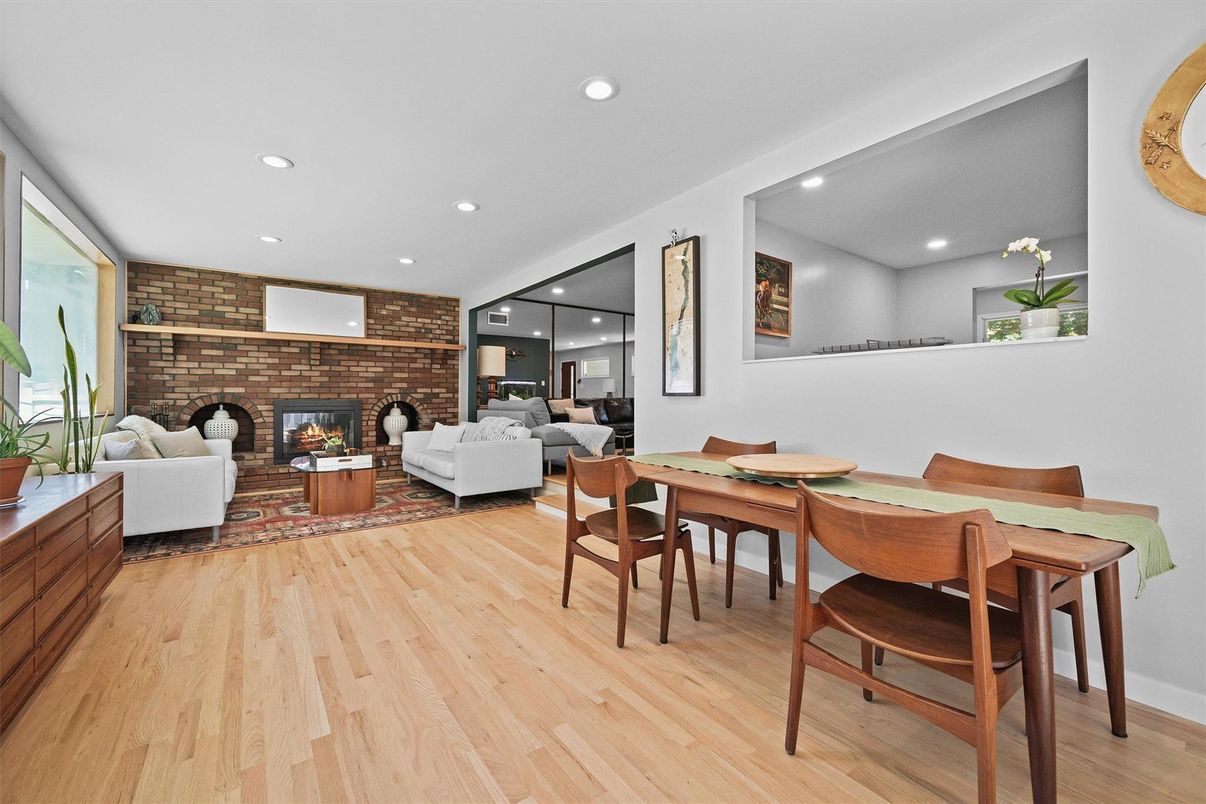 Dining room, Fireplace, Interior, Living room, Recessed Lighting, Stone Walls, Wood Texture Flooring