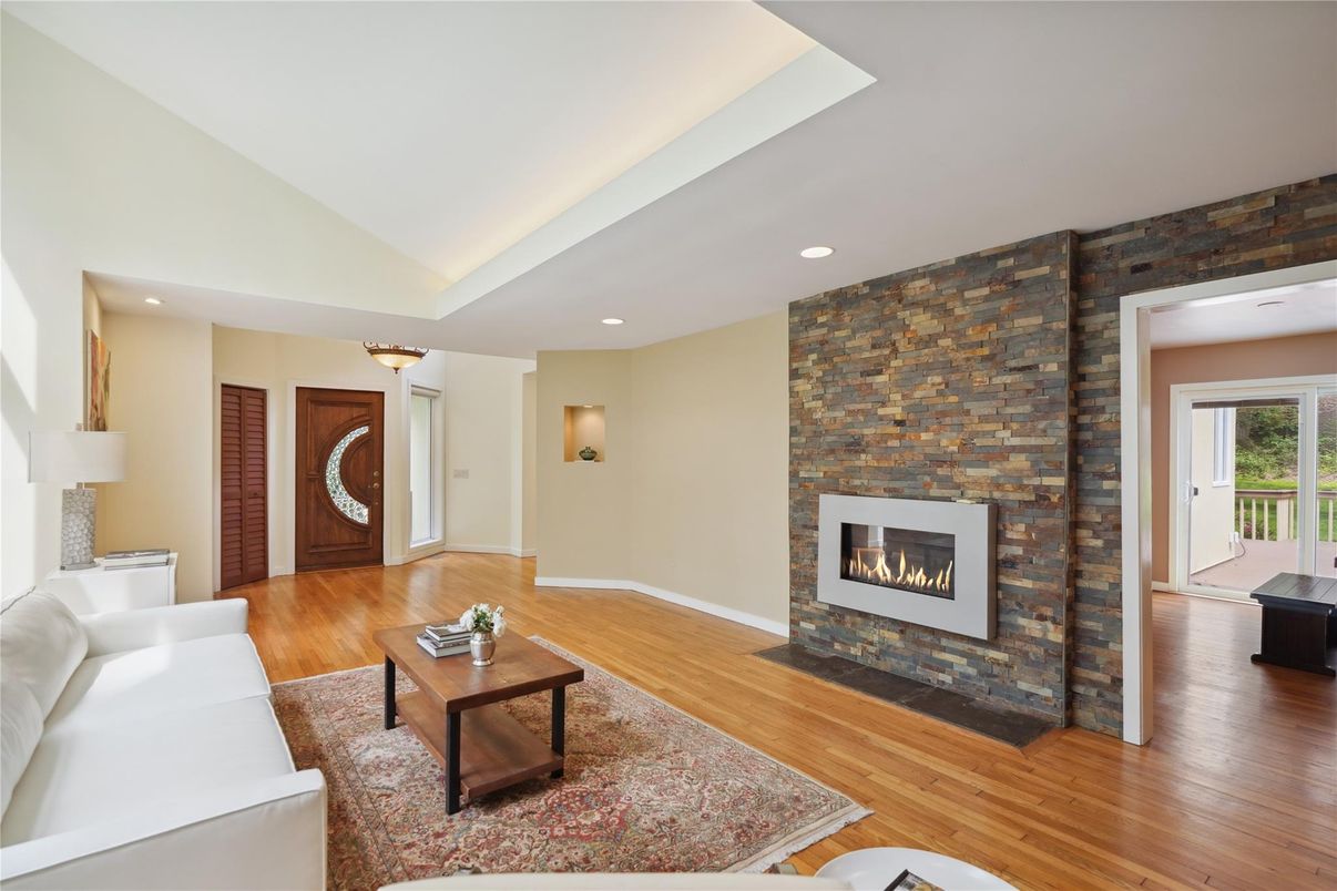 Fireplace, Interior, Living room, Recessed Lighting, Stone Walls, Wood Texture Flooring