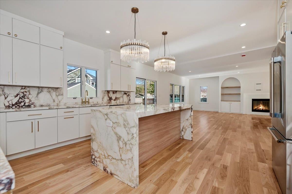 Chandelier, Fireplace, Interior, Kitchen, Marble Walls, Pendant Lights, Recessed Lighting, Wood Texture Flooring